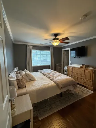 a bedroom with a bed and a large window