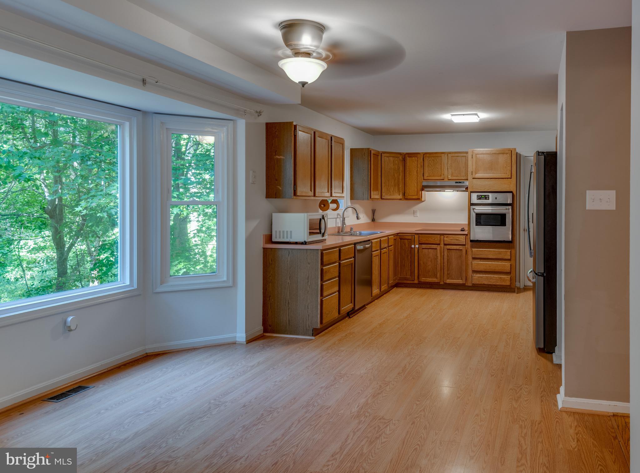 8413 Manor View Road Lusby, MD 20657 - Photo 11 of 48 a large kitchen with lots of counter space a sink and appliances