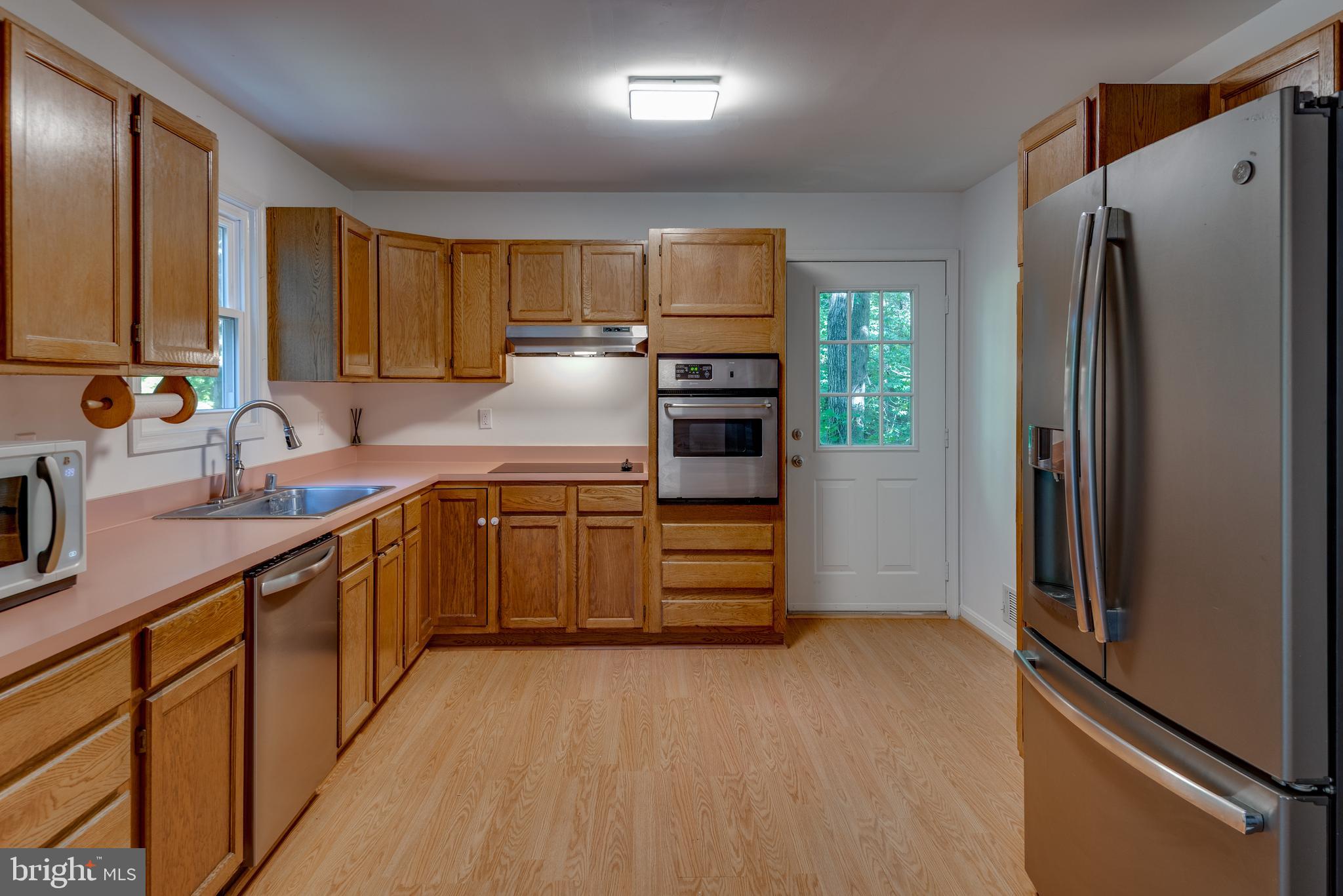 8413 Manor View Road Lusby, MD 20657 - Photo 14 of 48 a kitchen with stainless steel appliances a refrigerator sink and stove