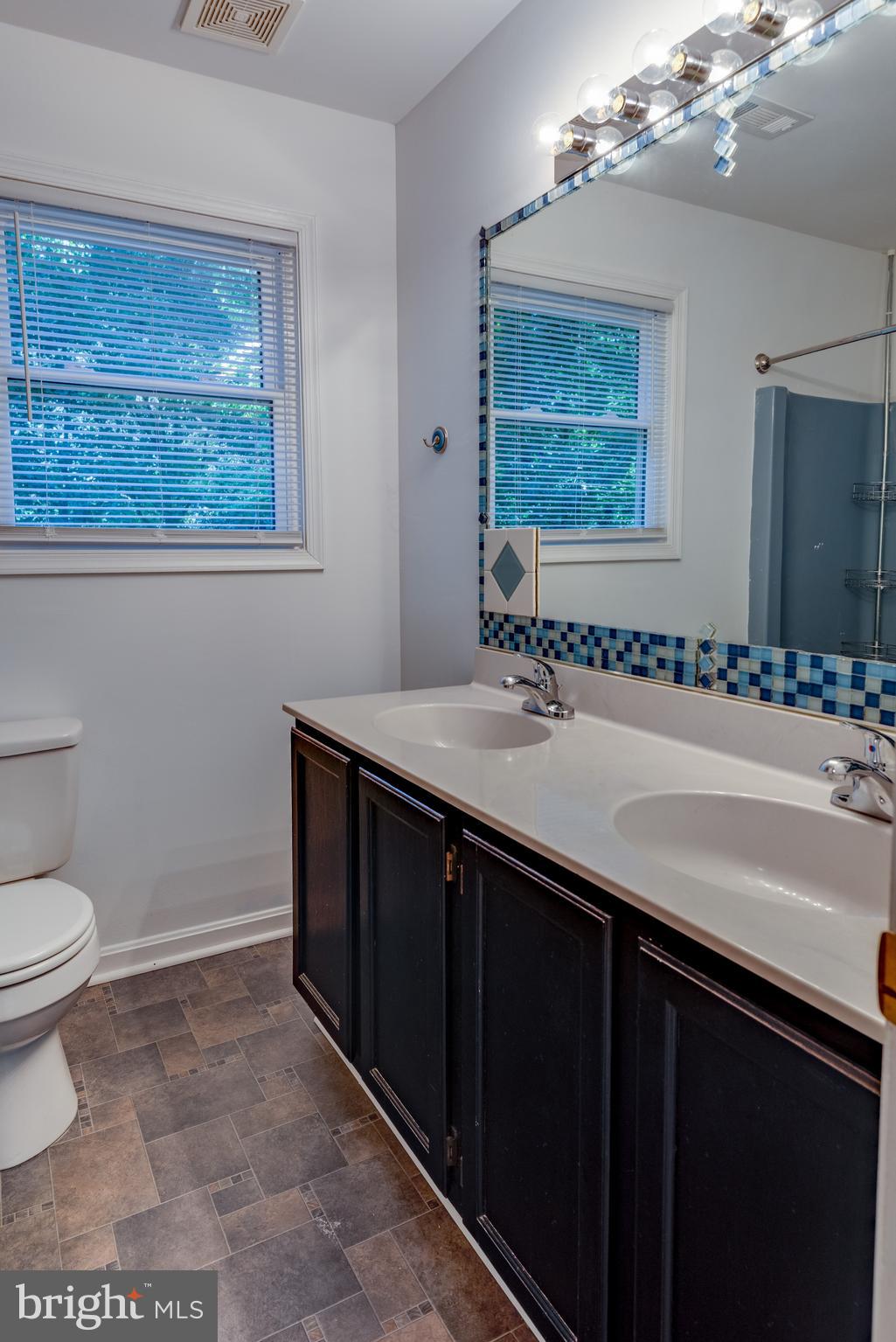 8413 Manor View Road Lusby, MD 20657 - Photo 27 of 48 a bathroom with a sink a toilet and mirror