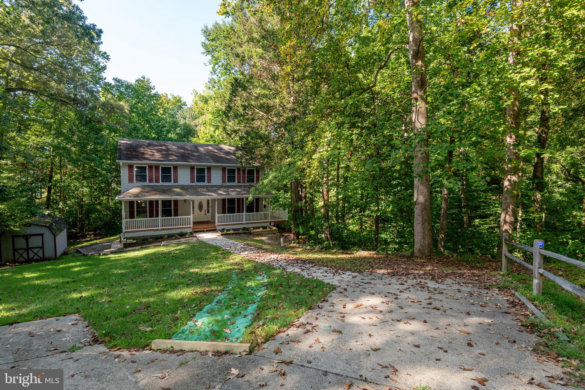 8413 Manor View Road Lusby, MD 20657 - Photo 47 of 48 a view of a house with backyard sitting area and garden