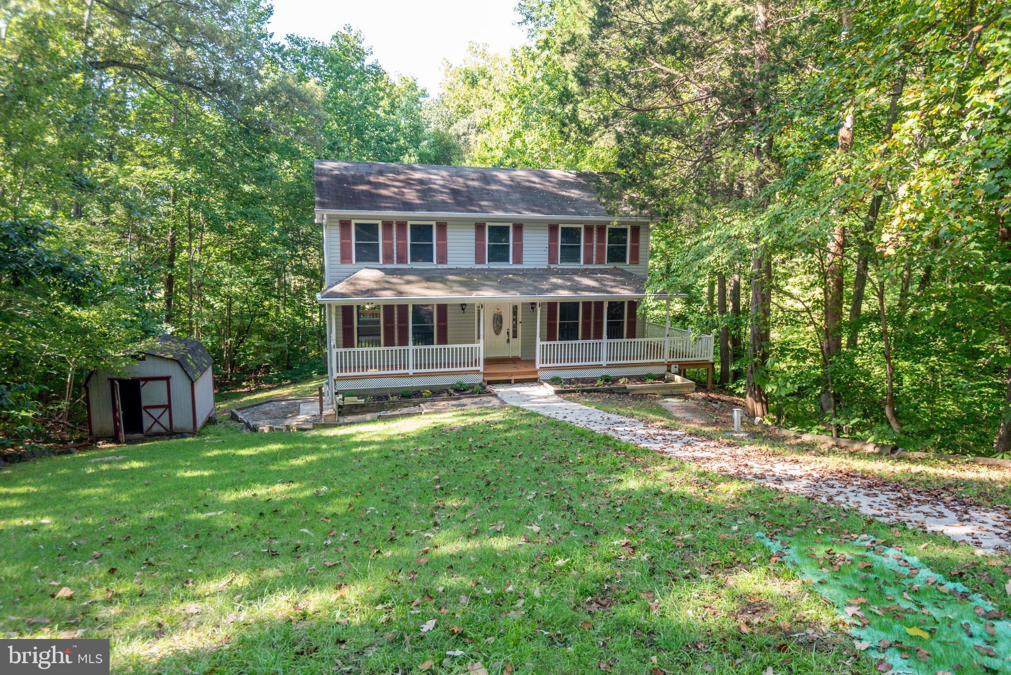 8413 Manor View Road Lusby, MD 20657 - Photo 48 of 48 a view of a house with a yard patio and a tree