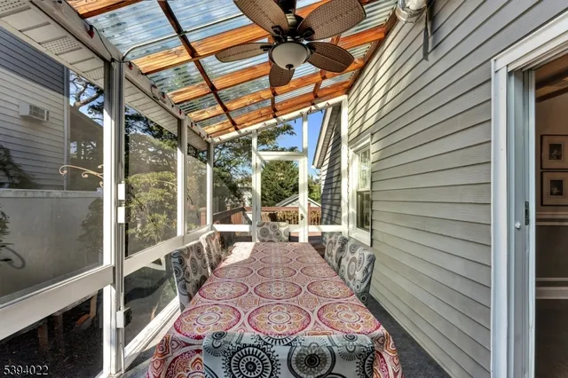 a view of a patio with table and chairs and wooden floor