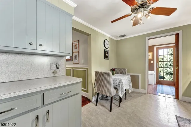 a kitchen with white cabinets and white appliances