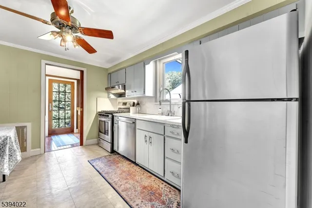 a view of living room with furniture and wooden floor