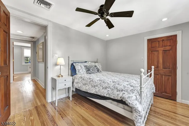 a bed sitting in a bedroom and a chandelier