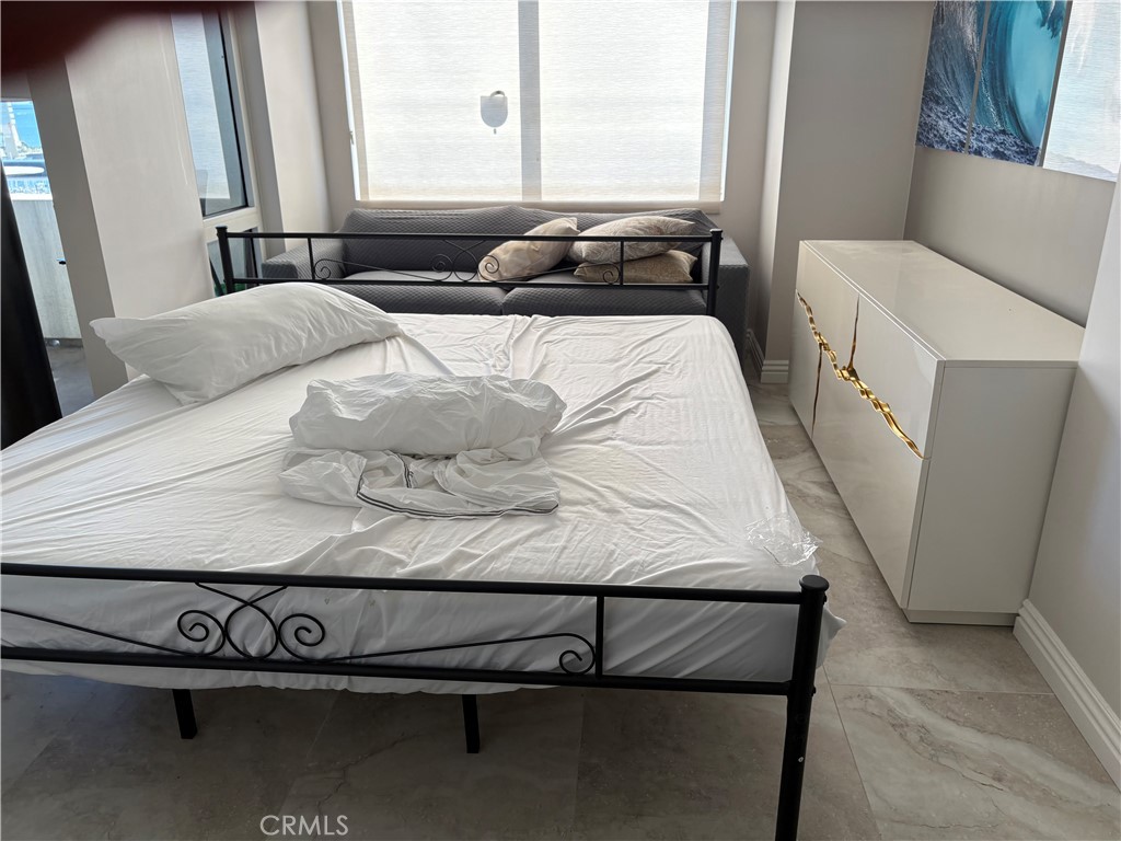 525 East Seaside Way, Unit 1505 Long Beach, CA 90802 - Photo 12 of 47 a living room with furniture and a window