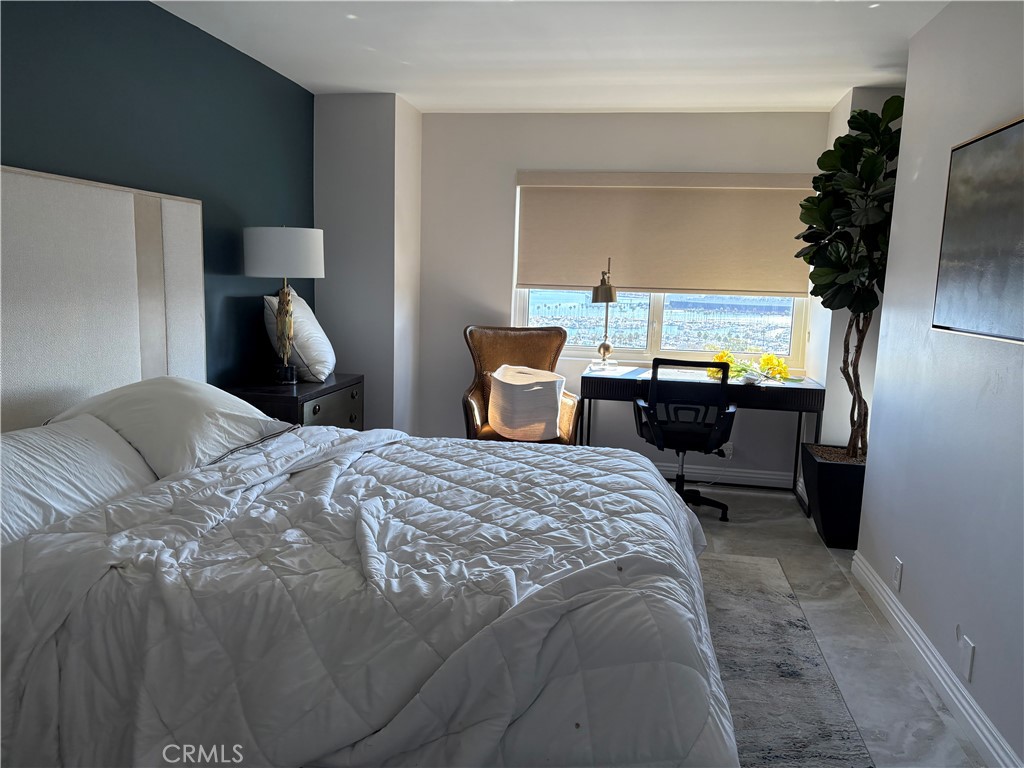 525 East Seaside Way, Unit 1505 Long Beach, CA 90802 - Photo 8 of 47 a bedroom with a bed and wooden floor