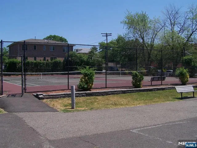 a view of a patio with table and chairs under an umbrella