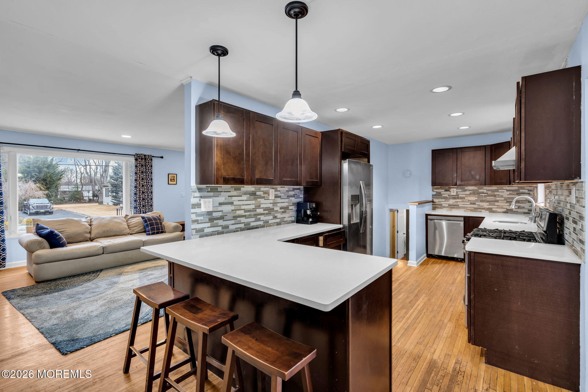 38 Hilltop Road West Long Branch, NJ 07764 - Photo 12 of 28 a kitchen with stainless steel appliances kitchen island granite countertop a dining table chairs sink refrigerator and granite counter top