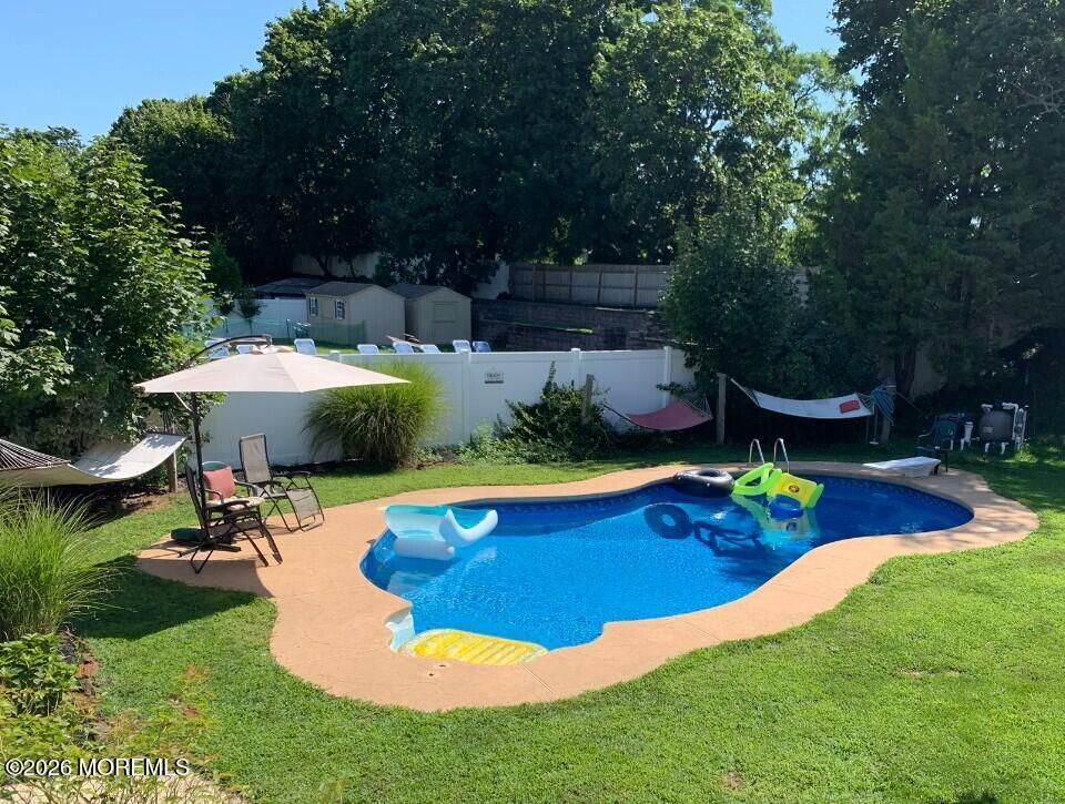 38 Hilltop Road West Long Branch, NJ 07764 - Photo 3 of 28 a view of a swimming pool with lawn chairs under an umbrella