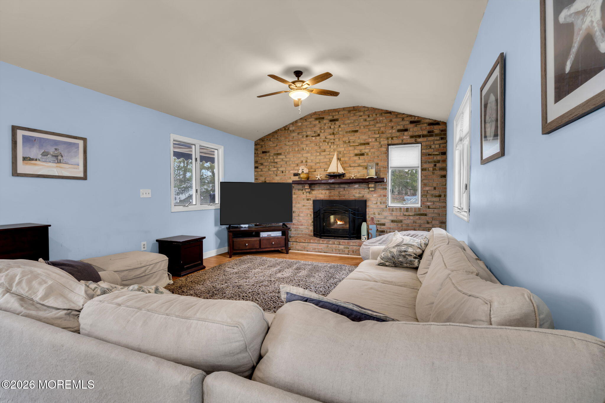 38 Hilltop Road West Long Branch, NJ 07764 - Photo 8 of 28 a living room with furniture a fireplace and a flat screen tv