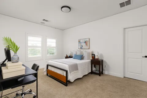 a spacious bedroom with a bed and a table