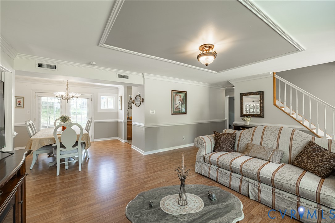 9217 Fisk Road Richmond, VA 23229 - Photo 9 of 39 a living room with furniture wooden floor and a large window