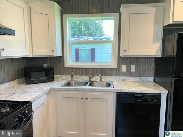 8220 Airport Road Bath, PA 18014 - Photo 10 of 25 a kitchen with a sink stove and cabinets
