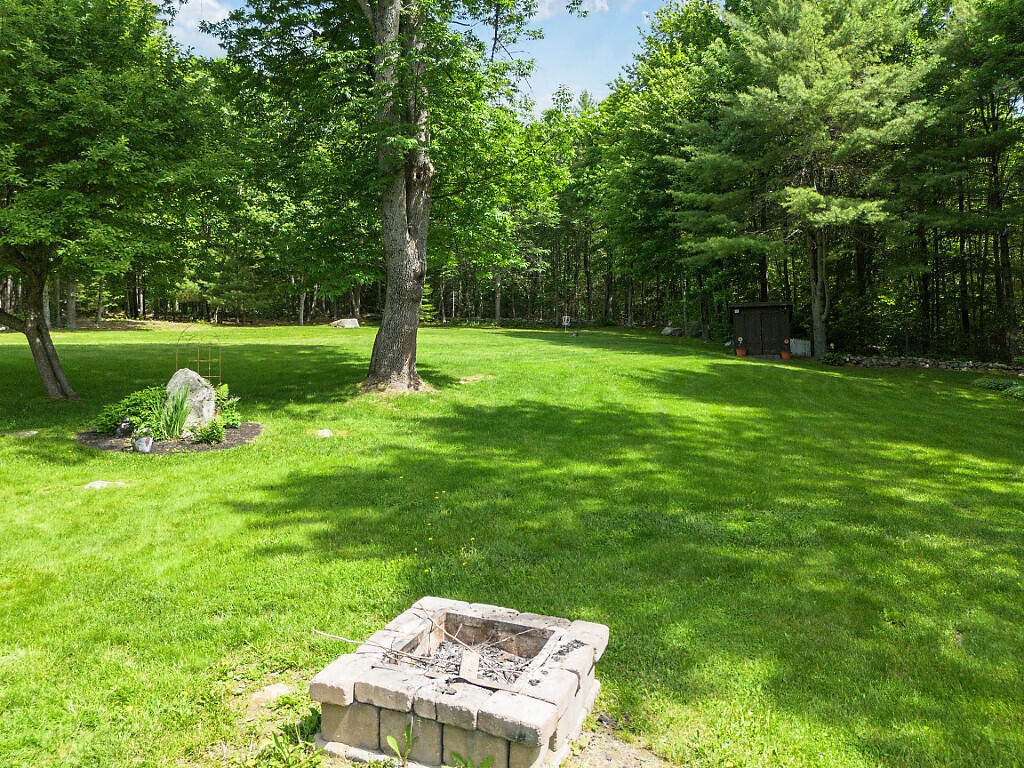 277 Wooster Hill Road Rome, ME 04963 - Photo 9 of 49 Firepit and plush grounds