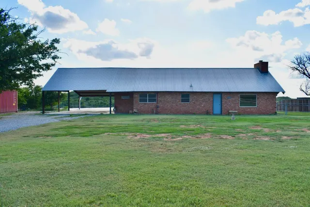 a front view of house with yard and green space