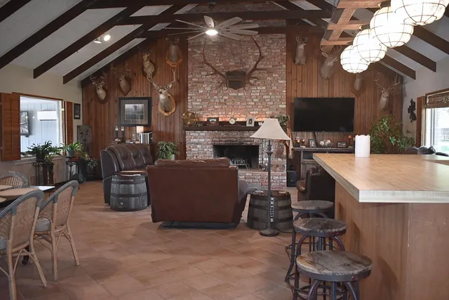 a dining room with furniture potted plants and wooden floor