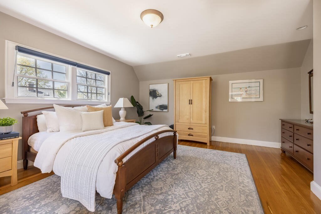 7 Pierrepont Road Winchester, MA 01890 - Photo 24 of 38 a bedroom with a bed and wooden floor