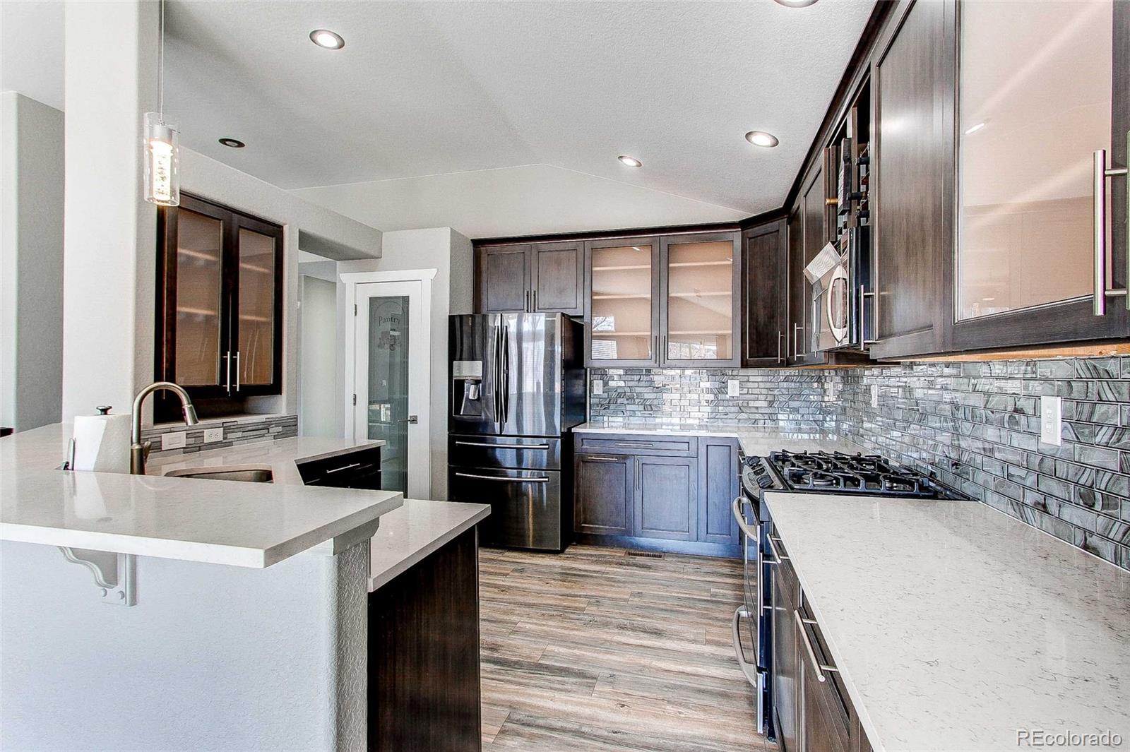 16082 Butterwort Circle Parker, CO 80134 - Photo 13 of 39 a kitchen with a sink stove and refrigerator