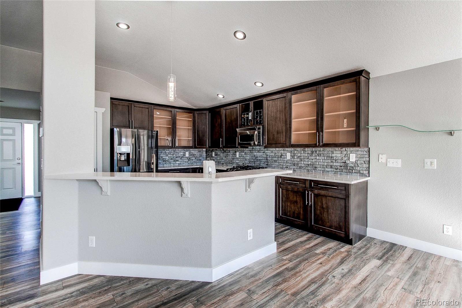 16082 Butterwort Circle Parker, CO 80134 - Photo 14 of 39 a kitchen with stainless steel appliances granite countertop a sink and stove top oven