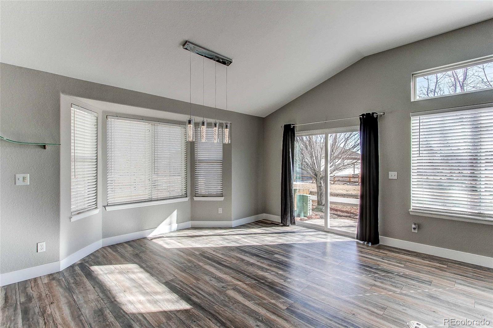 16082 Butterwort Circle Parker, CO 80134 - Photo 15 of 39 a view of an empty room with wooden floor and a window