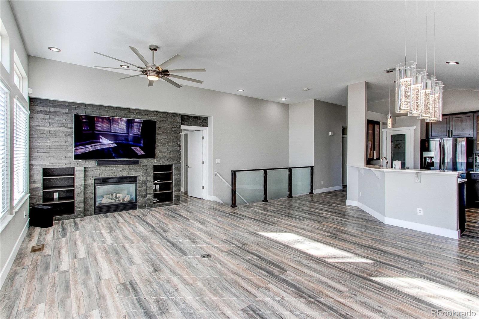 16082 Butterwort Circle Parker, CO 80134 - Photo 17 of 39 a living room with stainless steel appliances furniture a fireplace and a flat screen tv