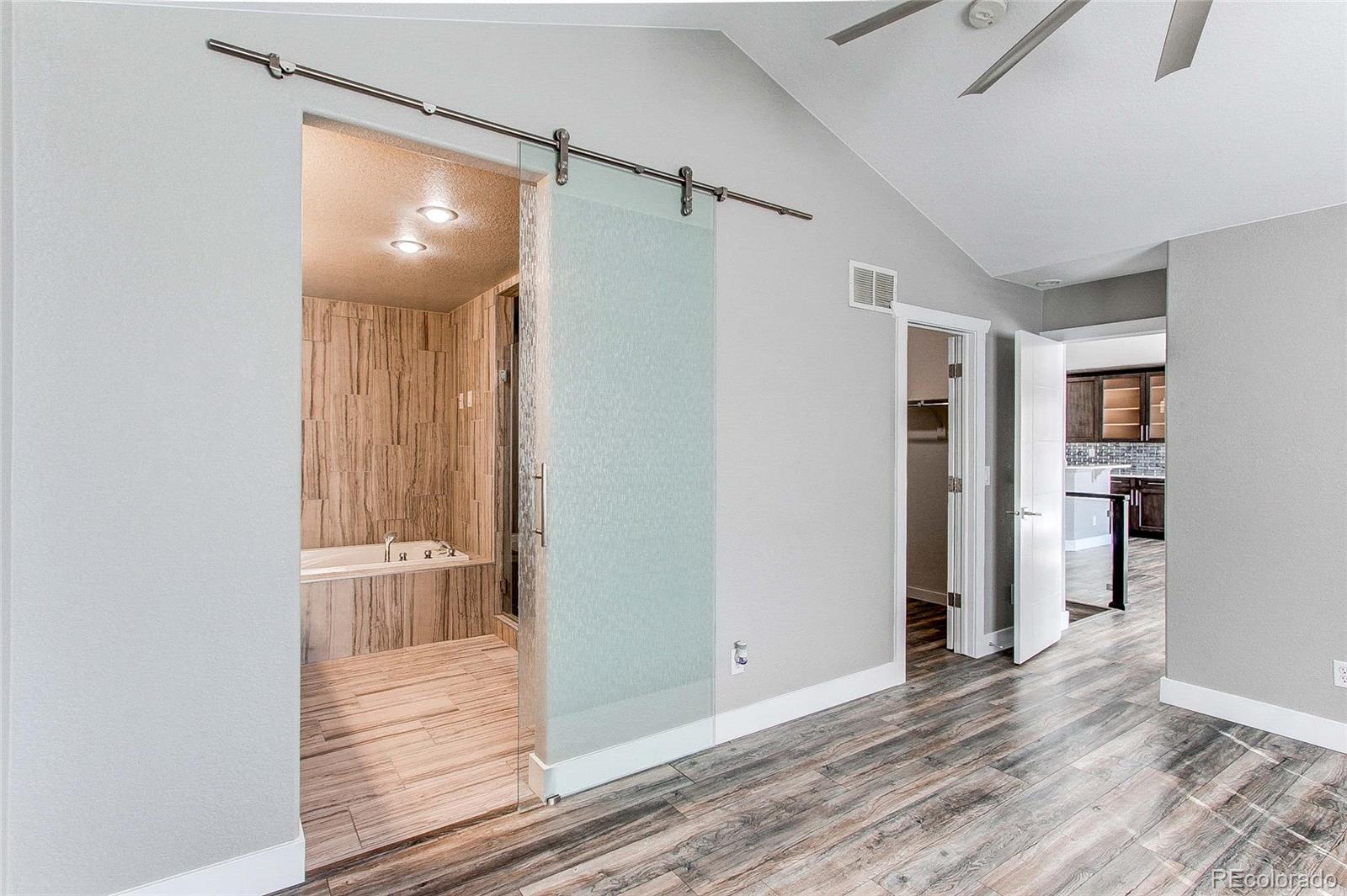16082 Butterwort Circle Parker, CO 80134 - Photo 22 of 39 a view of a hallway with wooden floor and closet