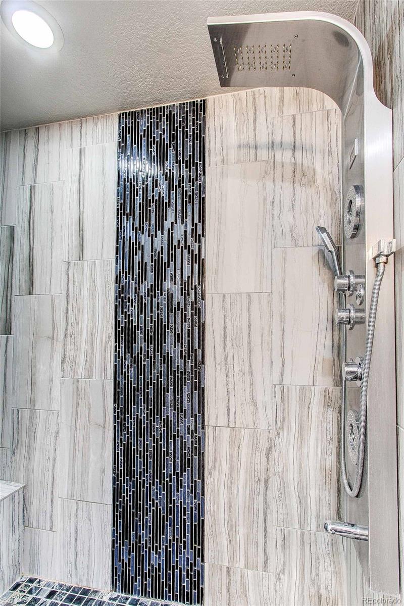 16082 Butterwort Circle Parker, CO 80134 - Photo 26 of 39 a bathroom with a shower curtain and a shower curtain