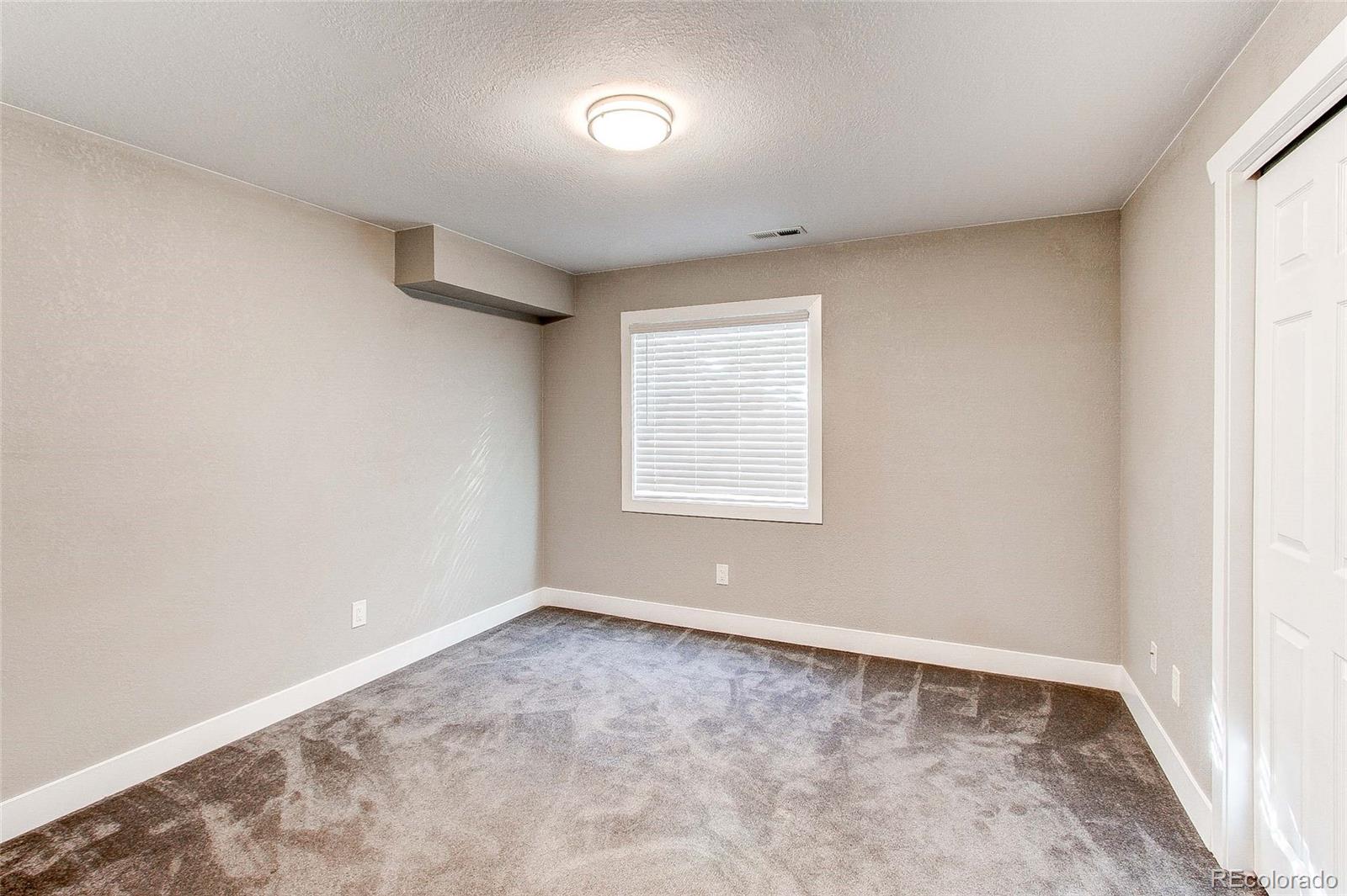16082 Butterwort Circle Parker, CO 80134 - Photo 34 of 39 a view of an empty room with a window