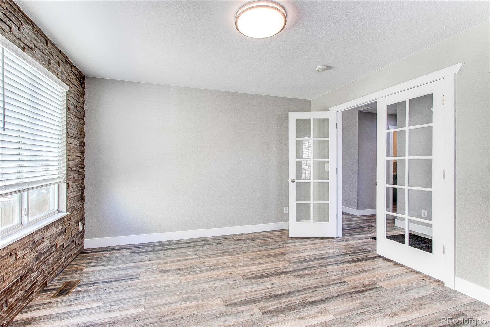 16082 Butterwort Circle Parker, CO 80134 - Photo 6 of 39 a view of an empty room with wooden floor and a window