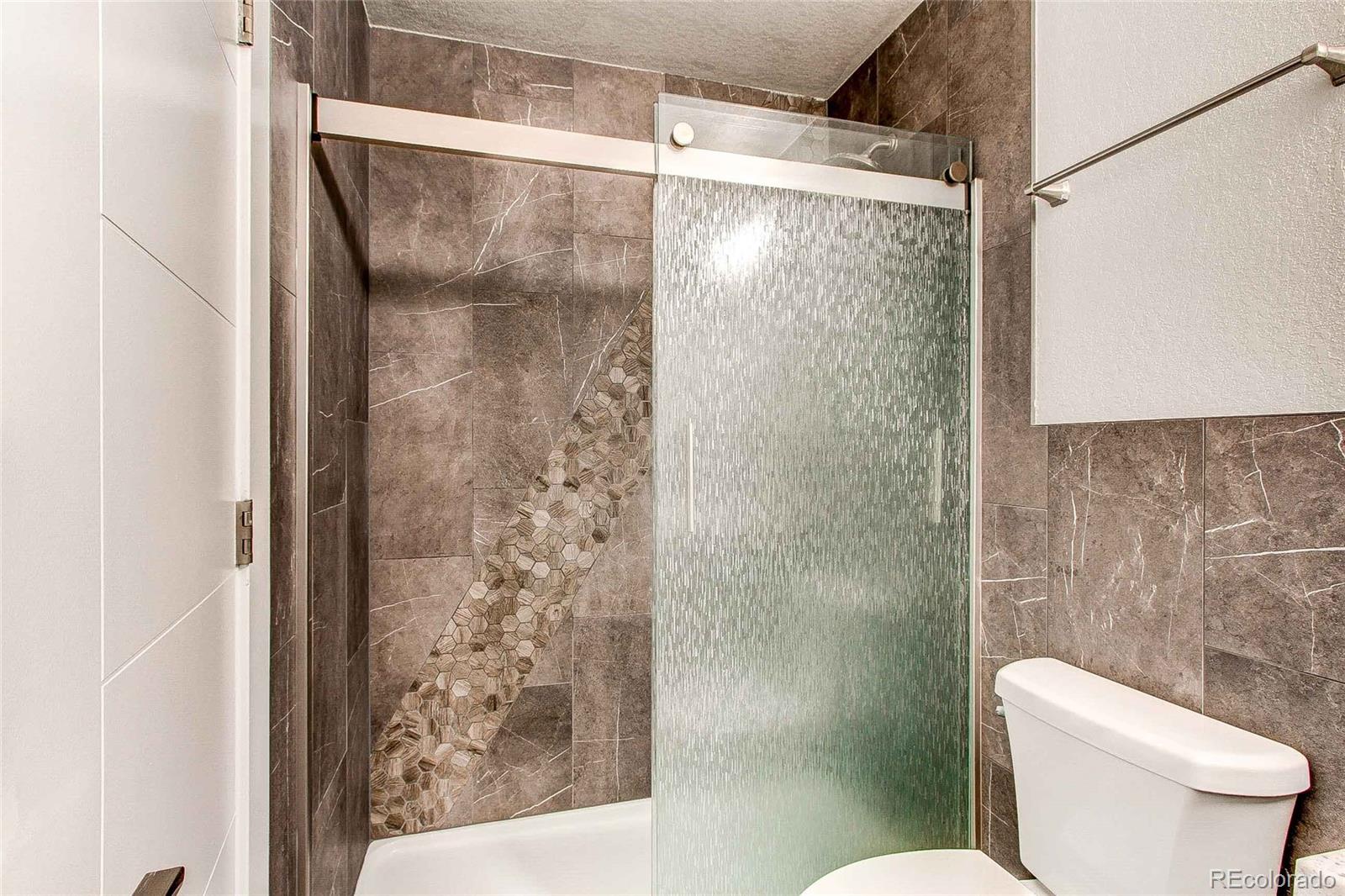 16082 Butterwort Circle Parker, CO 80134 - Photo 8 of 39 a bathroom with a shower and toilet