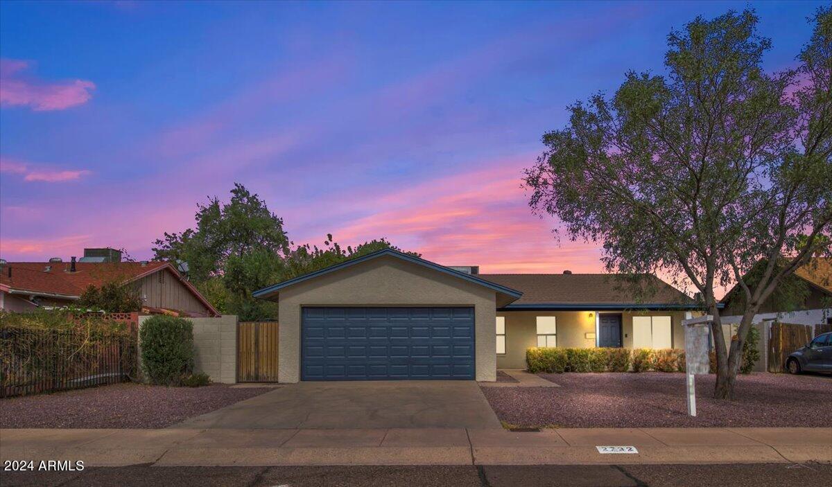 2732 East Cactus Road Phoenix, AZ 85032 - Photo 1 of 30 a front view of a house with a yard and garage