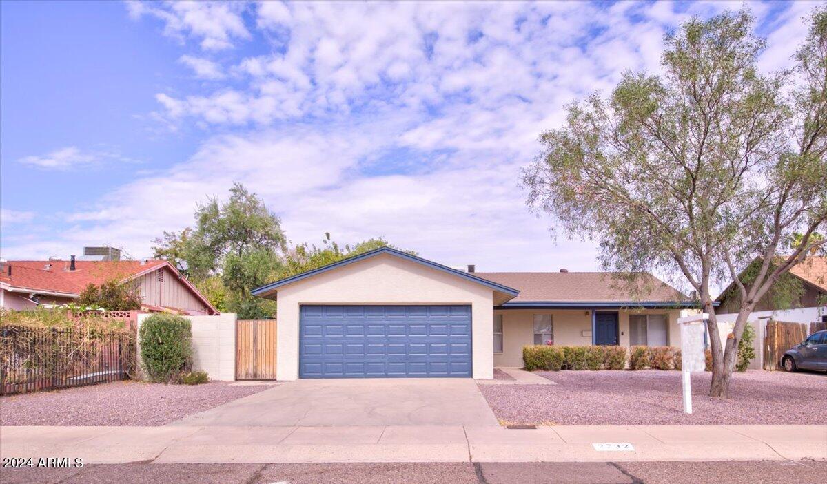 2732 East Cactus Road Phoenix, AZ 85032 - Photo 30 of 30 a front view of a house with a yard and garage