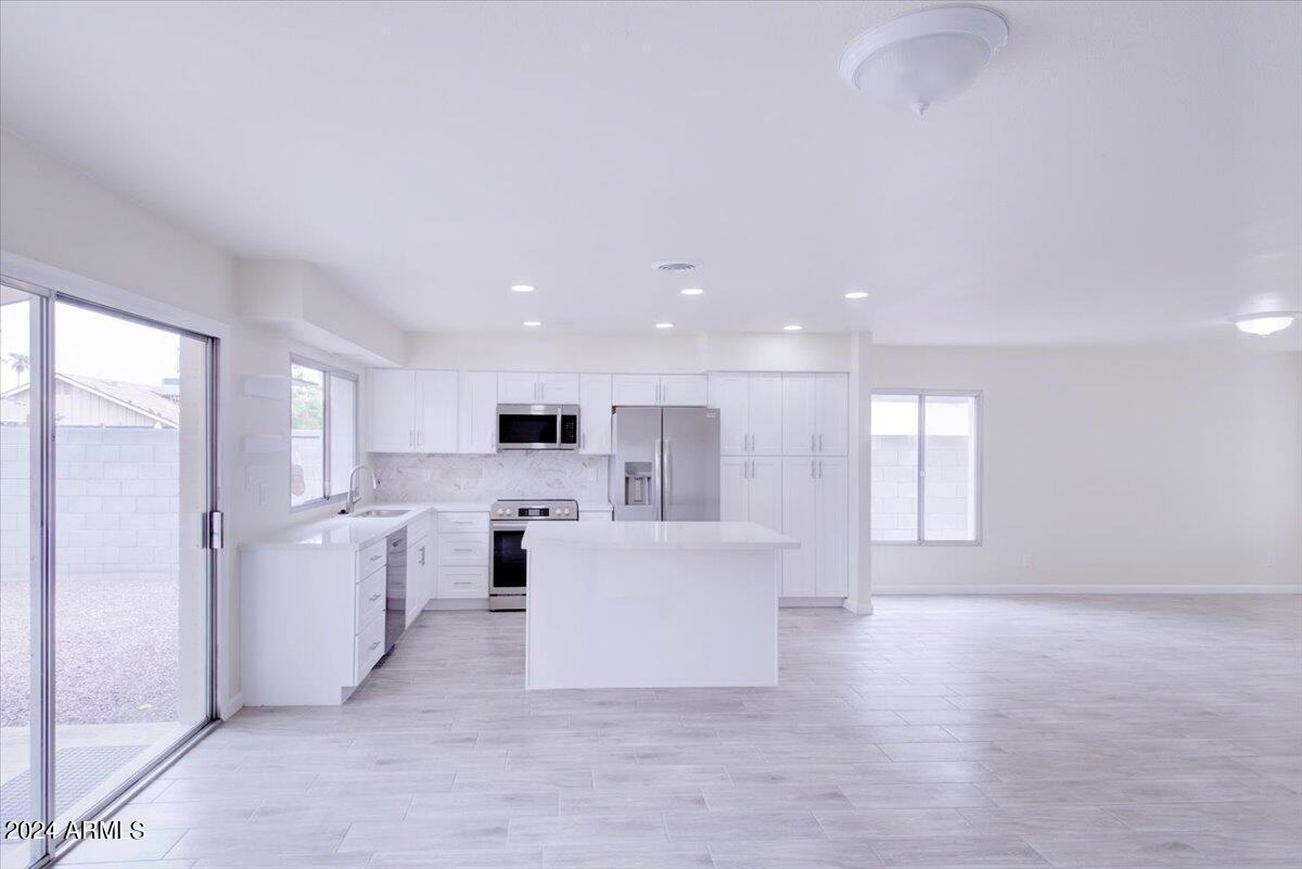 2732 East Cactus Road Phoenix, AZ 85032 - Photo 3 of 30 a view of a kitchen with refrigerator and windows