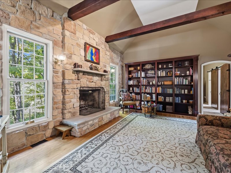 1168 Mt Pleasant Road Bangor, PA 18013 - Photo 43 of 100 Exposed ceiling beams and a floor-to-ceiling stone fireplace anchor this welcoming room.