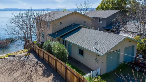 a view of house with staircase and wooden fence