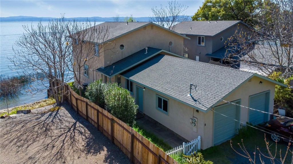 a view of house with staircase and wooden fence