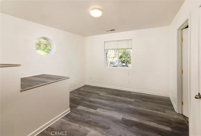 an empty room with windows and closet