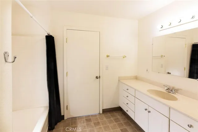 a bathroom with a double vanity sink and mirror