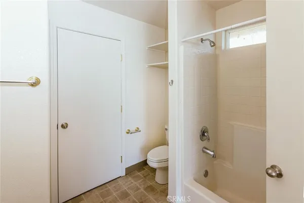 a bathroom with a granite countertop toilet a sink and shower