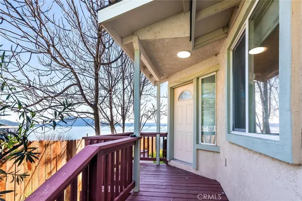 a view of a balcony with wooden floor and outdoor space