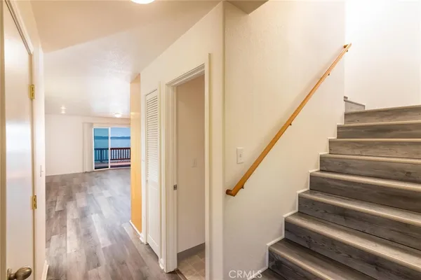 a view of an entryway with wooden floor and stairs
