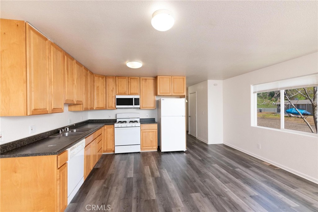 4571 State Highway 20 Nice, CA 95464 - Photo 7 of 24 a kitchen with granite countertop wooden floors and stainless steel appliances