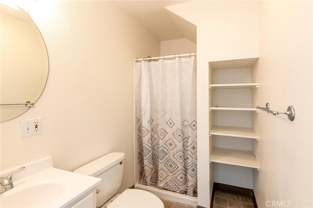 4571 State Highway 20 Nice, CA 95464 - Photo 9 of 24 a bathroom with a toilet and a shower curtain