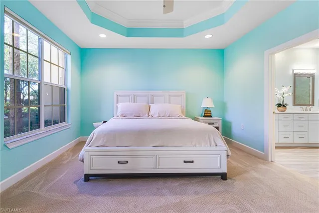 a spacious bedroom with a bed and a window