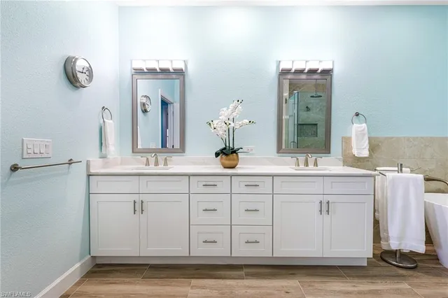 a bathroom with a sink vanity and mirror