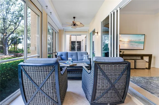 a living room with furniture a rug and a large window