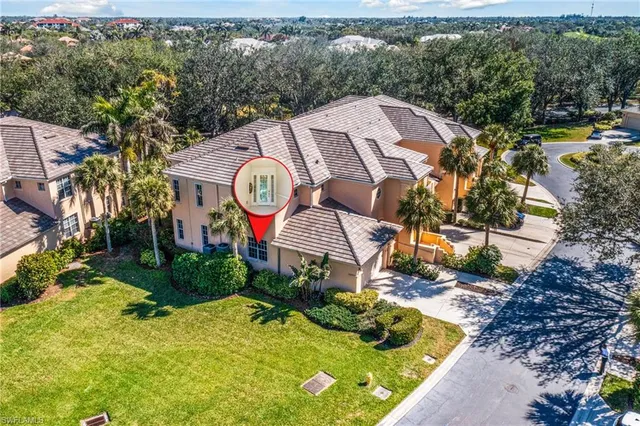 an aerial view of a house with a yard and outdoor seating