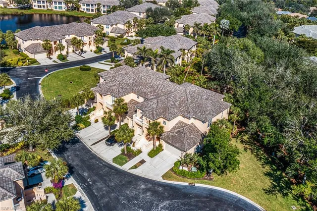 an aerial view of a house with a yard and lake view